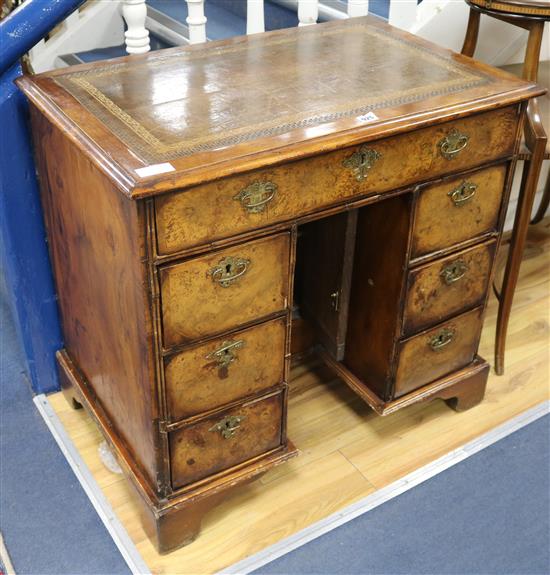 A George I style walnut kneehole desk W.81cm